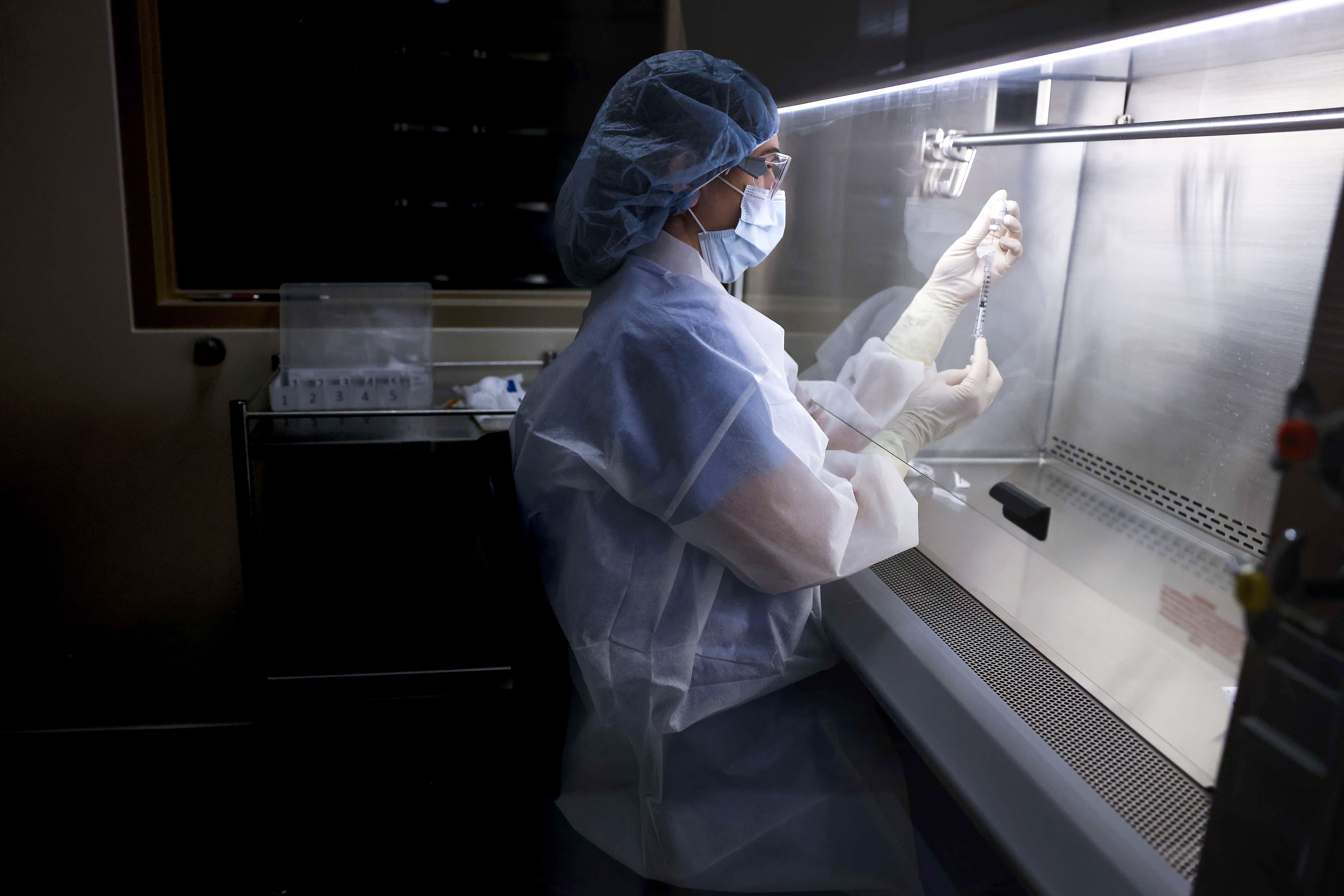 Une technicienne de Johnson & Johnson prépare une dose de vaccin lors d’un essai clinique.