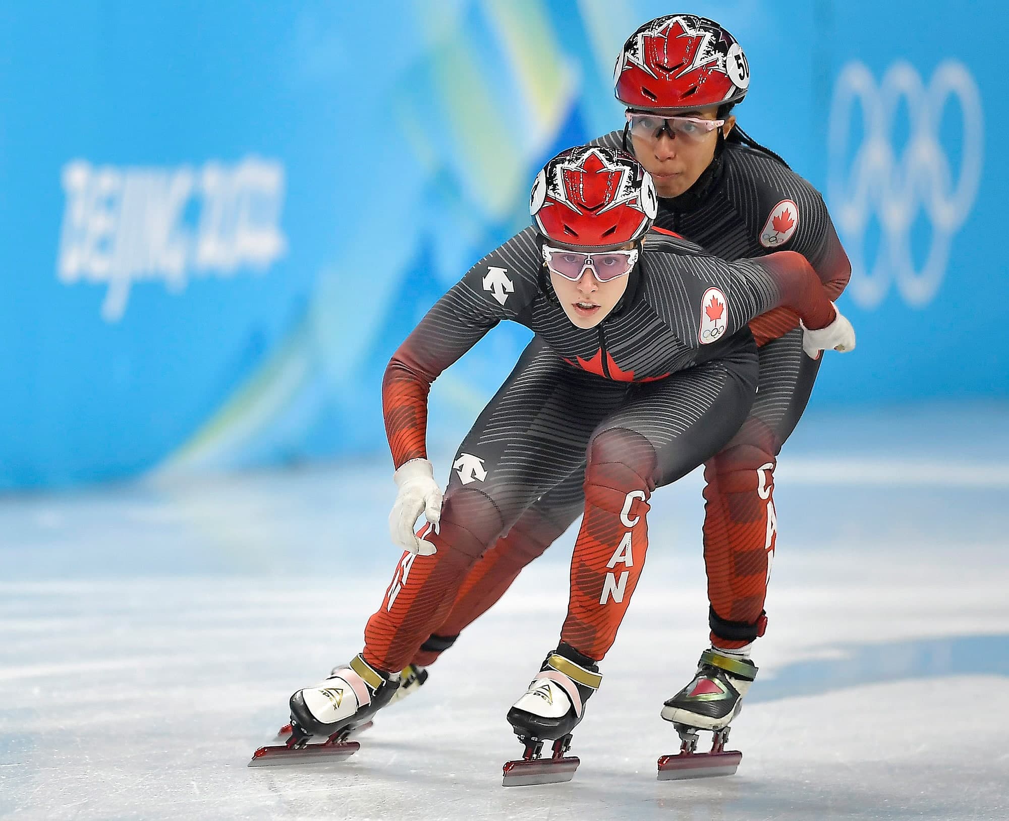 Florence Brunelle reçoit la poussée d’Alyson Charles en action lors de la demi-finale du relais 3000 mètres, mercredi, à Pékin.