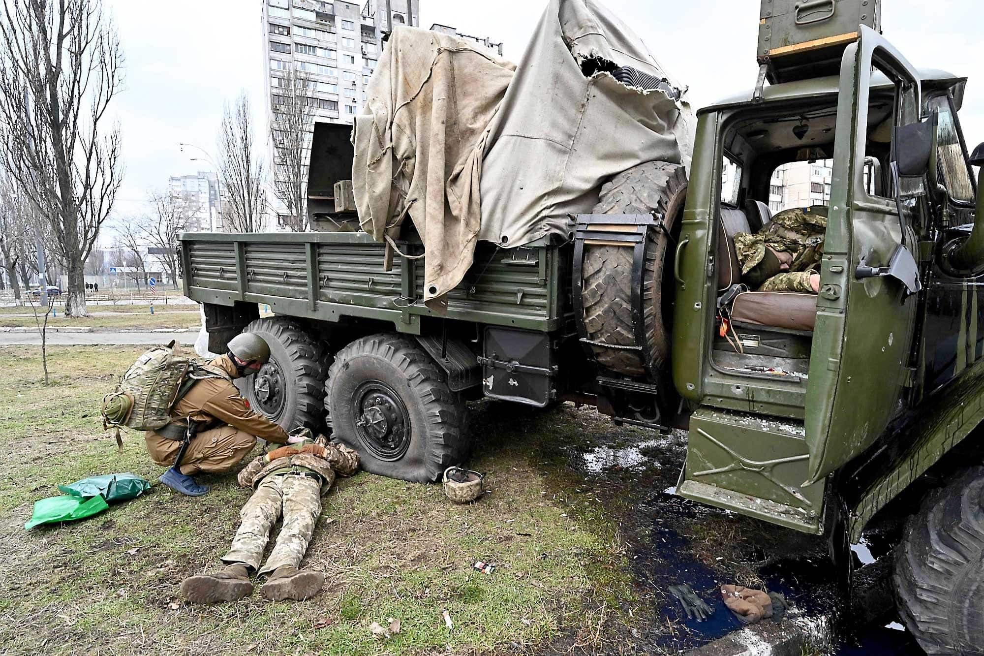 Un militaire ukrainien de l’équipe médicale constate le décès de deux soldats à Kiev.